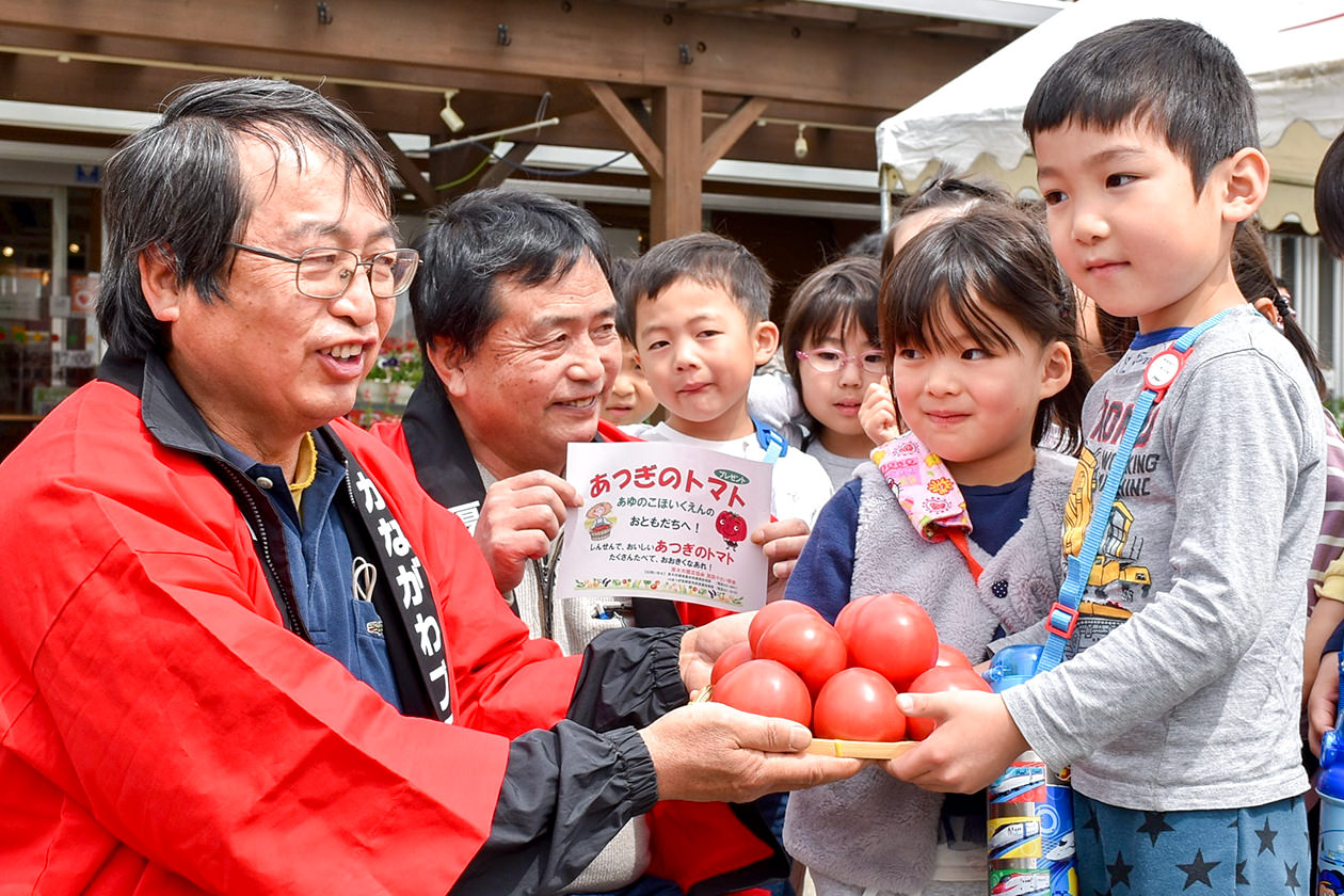 子どもたちに「厚木トマト」の魅力を伝える部会員の写真